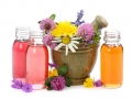 Mortar with fresh flowers and essential oil